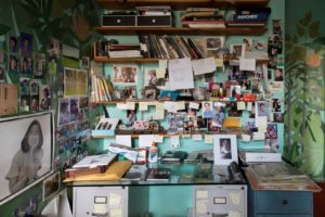 Alex Katz’s studio desk, with photos of his family, 2018 Gillian Laub photo.